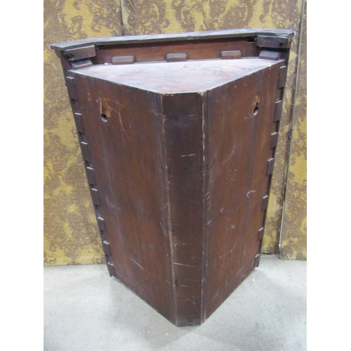 2188 - A Georgian pale oak and mahogany veneered hanging corner cupboard enclosed by a rectangular moulded ... 