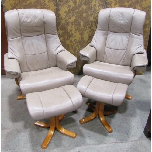 2194 - A pair of Stressless style swivel adjustable lounge chairs with cream coloured soft leather upholste... 