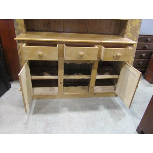 2250 - A reclaimed stripped pine kitchen dresser the base enclosed by an arrangement of cupboards and doors... 