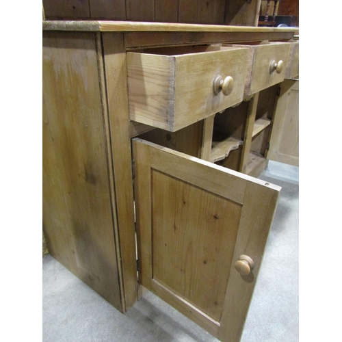 2250 - A reclaimed stripped pine kitchen dresser the base enclosed by an arrangement of cupboards and doors... 