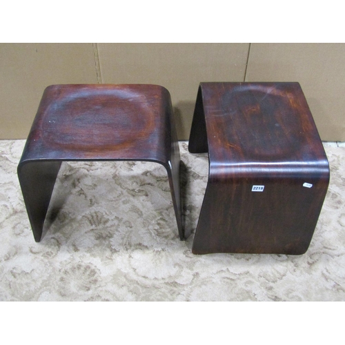 2219 - A pair of moulded stained plywood stools with oval dished seats