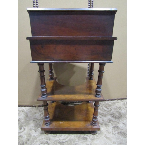 2224 - A Victorian walnut three tier writing desk with inlaid detail raised stationery compartment over a s... 