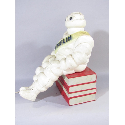 1558 - An Advertisement Lamp of the Michelin Man perched on a stack of four European Guide Books.