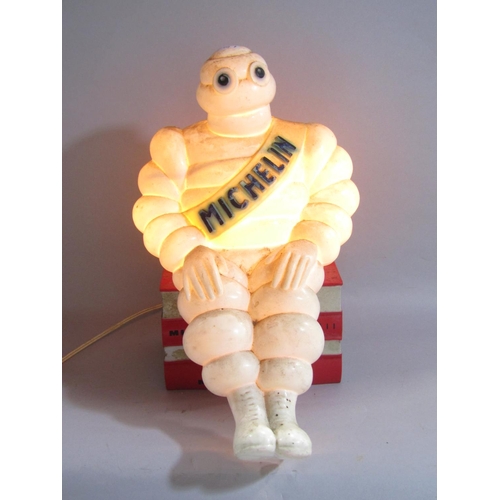 1558 - An Advertisement Lamp of the Michelin Man perched on a stack of four European Guide Books.