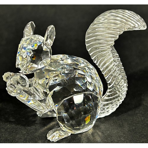 1117 - A small group of Swarovski crystal figures including a dragonfly, swan and a squirrel holding a diam... 