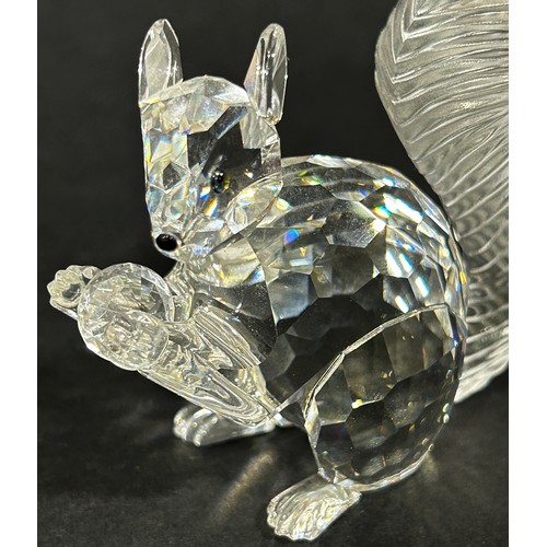 1117 - A small group of Swarovski crystal figures including a dragonfly, swan and a squirrel holding a diam... 