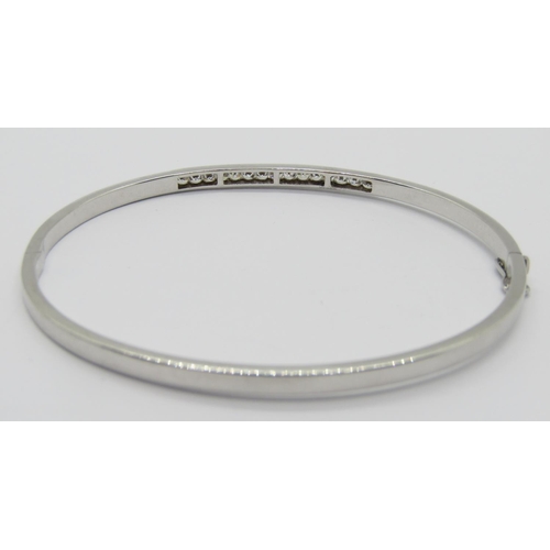 1361 - 9ct white gold hinged bangle channel set with cubic zirconia, 4.4g