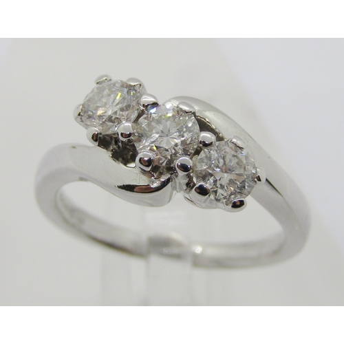 1363 - 18ct white gold three stone diamond crossover ring, each stone 0.20ct approx, maker 'RG', size J/K, ... 