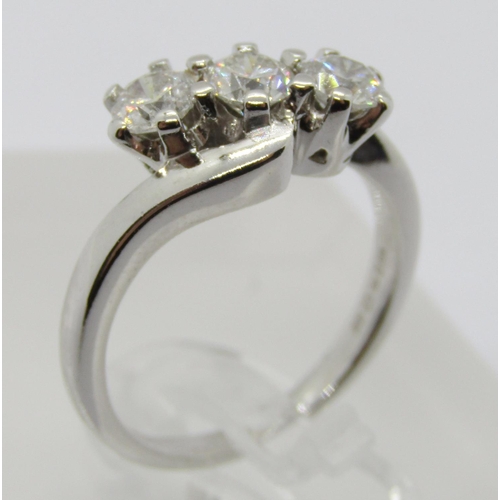 1363 - 18ct white gold three stone diamond crossover ring, each stone 0.20ct approx, maker 'RG', size J/K, ... 