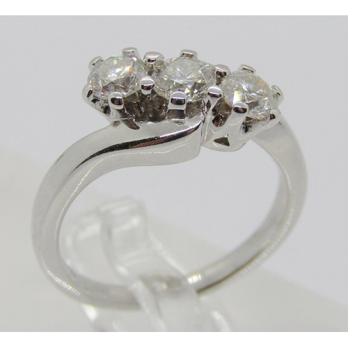 1363 - 18ct white gold three stone diamond crossover ring, each stone 0.20ct approx, maker 'RG', size J/K, ... 