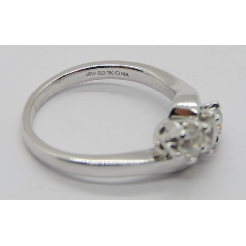 1363 - 18ct white gold three stone diamond crossover ring, each stone 0.20ct approx, maker 'RG', size J/K, ... 