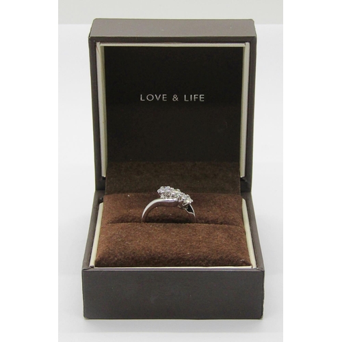 1363 - 18ct white gold three stone diamond crossover ring, each stone 0.20ct approx, maker 'RG', size J/K, ... 