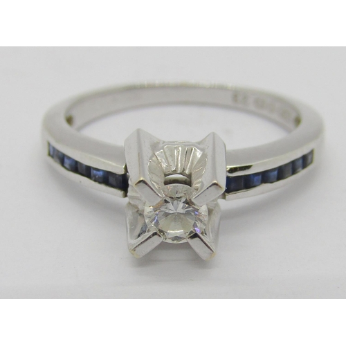 1365 - 18ct white gold diamond and channel set sapphire ring with raised setting, the diamond 0.20ct approx... 