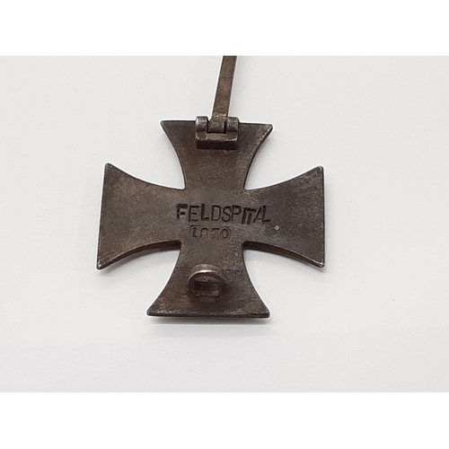 1799 - A Prussian 1870 iron cross tunic badge, stamped verso ‘FELDSPITAL’, 1870