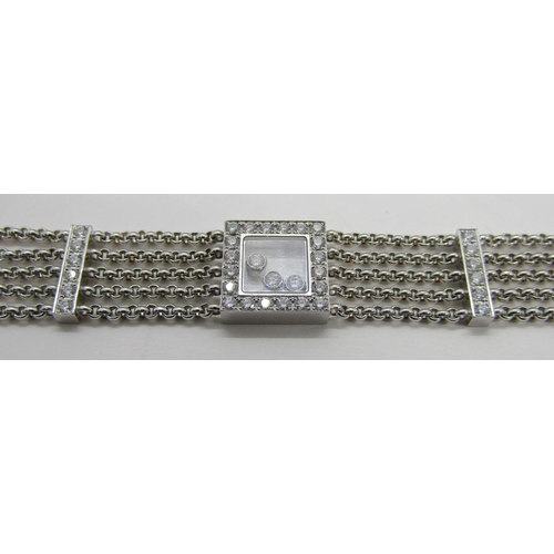 1369 - Chopard. An 18ct white gold ‘Happy Diamonds’ bracelet, on a five strand chain bracelet spaced with d... 