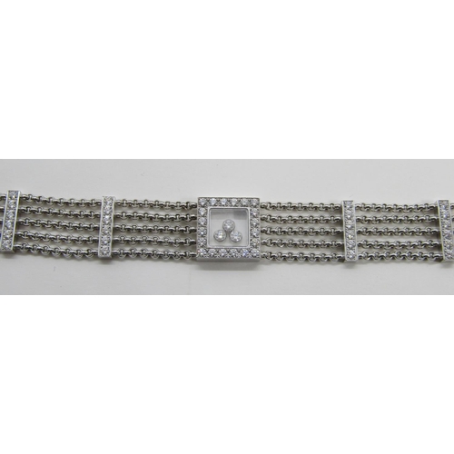 1369 - Chopard. An 18ct white gold ‘Happy Diamonds’ bracelet, on a five strand chain bracelet spaced with d... 