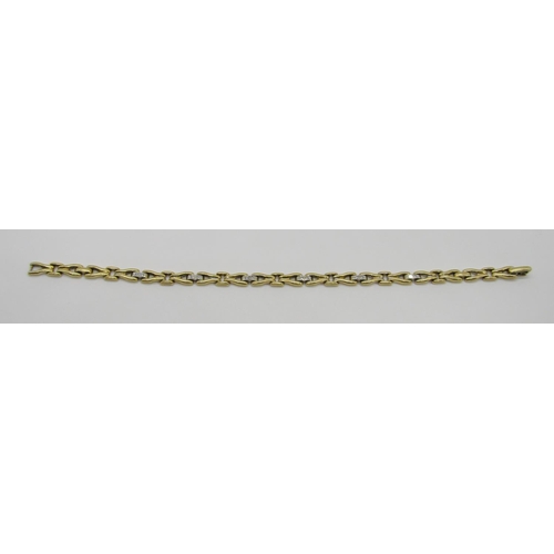 1370 - An 18ct yellow gold link bracelet, the links interspersed with six diamond couplings, 20cm long, sta... 