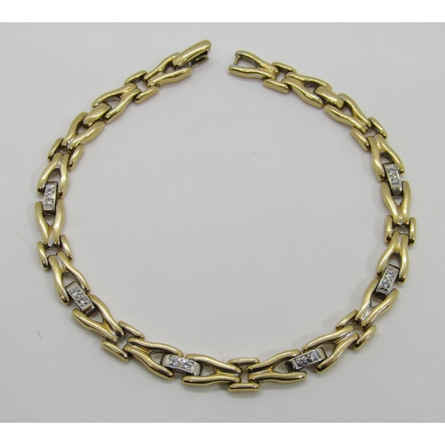 1370 - An 18ct yellow gold link bracelet, the links interspersed with six diamond couplings, 20cm long, sta... 