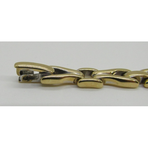 1370 - An 18ct yellow gold link bracelet, the links interspersed with six diamond couplings, 20cm long, sta... 