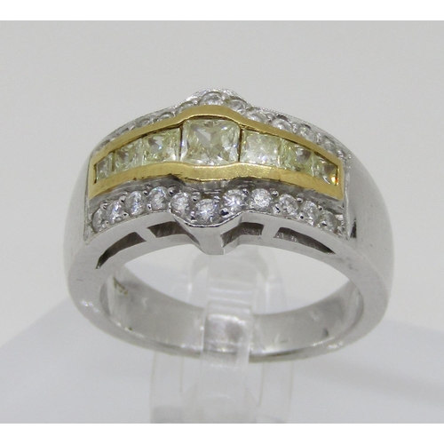 1371 - An 18ct white gold, fancy yellow and white diamond dress ring, with yellow gold mount enclosing seve... 