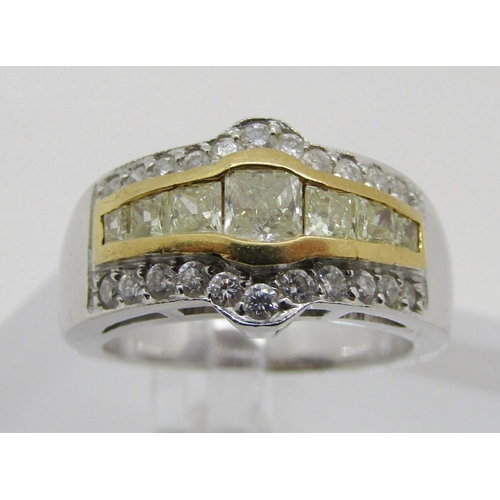 1371 - An 18ct white gold, fancy yellow and white diamond dress ring, with yellow gold mount enclosing seve... 