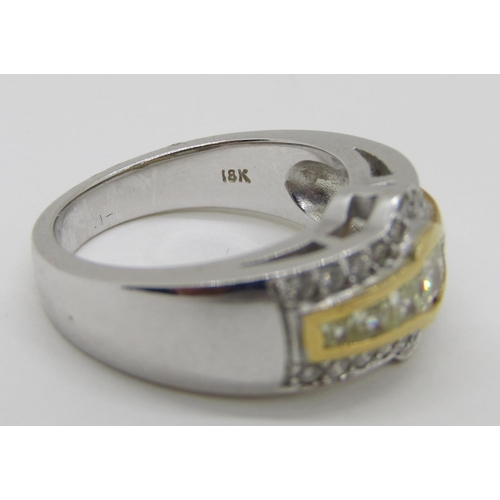 1371 - An 18ct white gold, fancy yellow and white diamond dress ring, with yellow gold mount enclosing seve... 