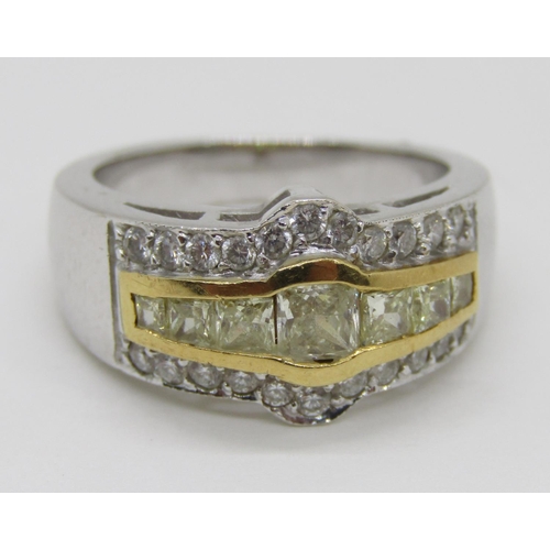 1371 - An 18ct white gold, fancy yellow and white diamond dress ring, with yellow gold mount enclosing seve... 