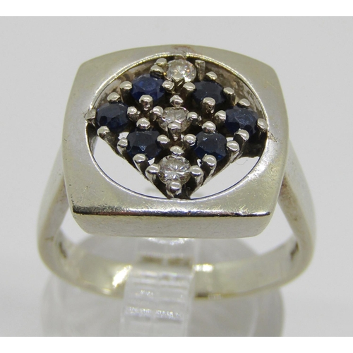 1376 - An unusual 18ct white gold, sapphire and diamond set dress ring, with openwork mount, size N/O, 10g