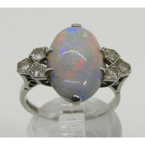 1377 - An antique platinum, opal and diamond dress ring, the central opal flanked with diamond-set shoulder... 