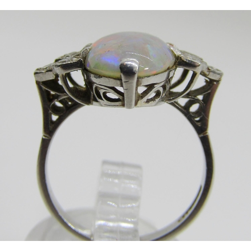 1377 - An antique platinum, opal and diamond dress ring, the central opal flanked with diamond-set shoulder... 