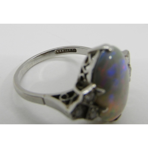 1377 - An antique platinum, opal and diamond dress ring, the central opal flanked with diamond-set shoulder... 