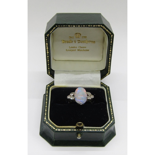 1377 - An antique platinum, opal and diamond dress ring, the central opal flanked with diamond-set shoulder... 