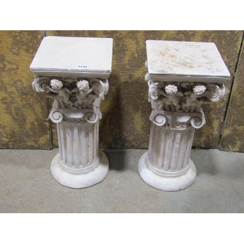 2125 - Pair of squat plaster cylindrical fluted columns with fixed caps, repeating winged cherub/putti deta... 