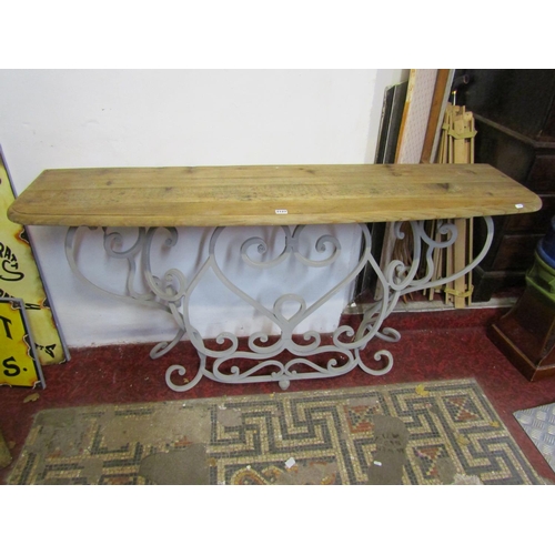 2127 - A contemporary steel framed console table, with scrolled detail and bevelled pine top, 81 cm high, 1... 