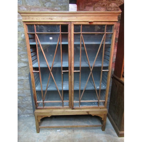 2199 - 19th century stripped pine display cabinet enclosed by a pair of astragal glazed panelled doors with... 