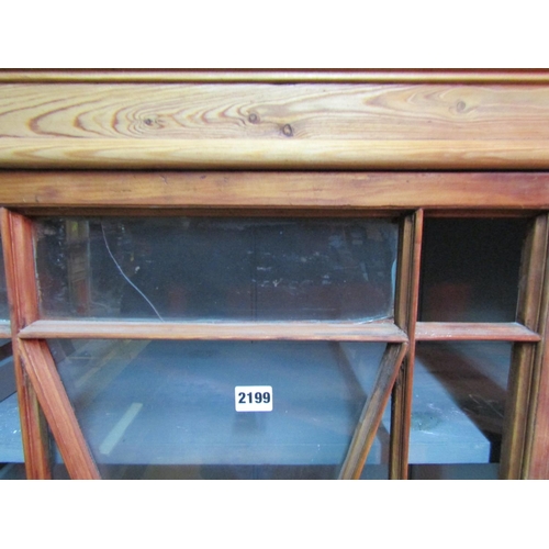 2199 - 19th century stripped pine display cabinet enclosed by a pair of astragal glazed panelled doors with... 