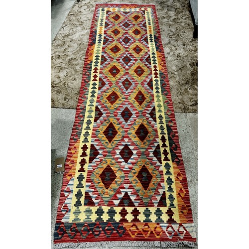 2712 - Chobi kilim runner, with a central panel of brightly coloured diamonds, 296cm x 80cm