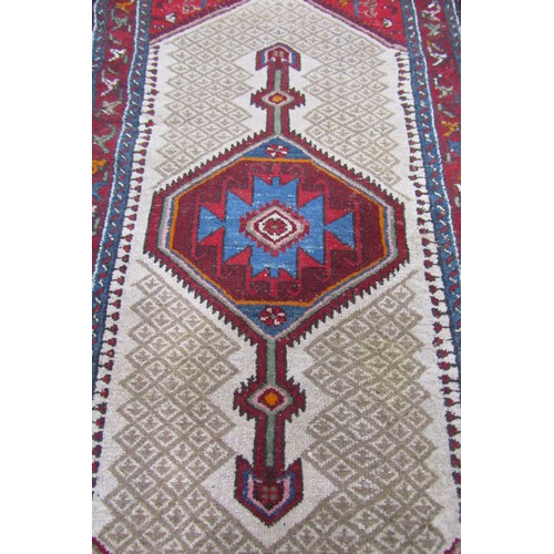 2710 - A Kamseh type rug with a central elongated medallion with a geometric border, 188cm 95cm.