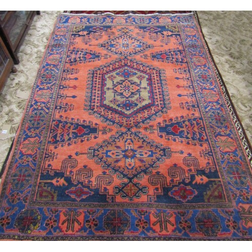 2721 - A Turkish Carpet with a central medallion flanked by two smaller on a predominantly peach ground and... 