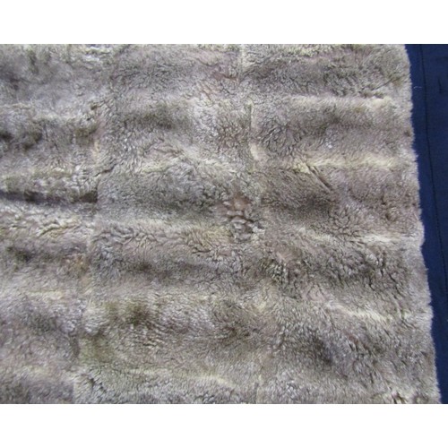 2729 - An opossum fur throw on a blue felt lining, 180cm x 160cm, together with a reversible two tone, brow... 