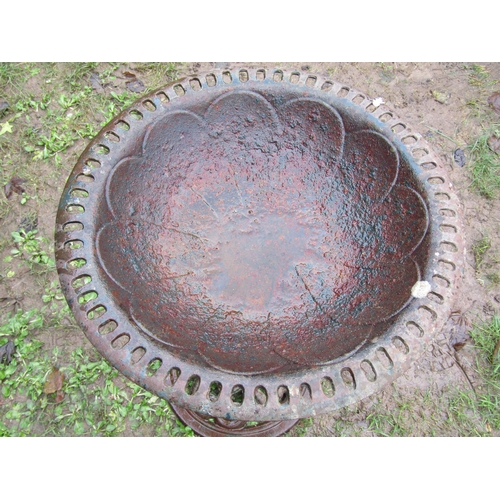 2060 - Weathered cast iron bird bath with circular pierced top, raised on a central pillar with pierced cir... 