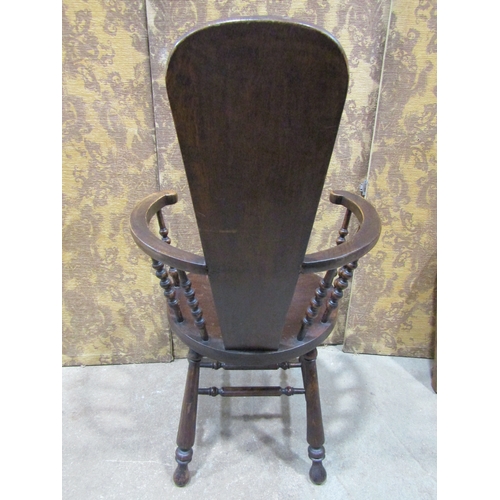 2196 - An Edwardian stained beechwood elbow chair with turned spindle back and solid dish seat