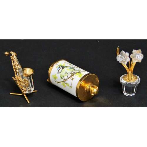 1116 - A group of Swarovski miniature pieces with gold gilt detail, including a cake, Saxophone ,a rowing b... 