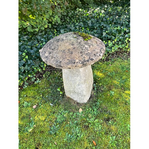 2117 - A traditional weathered natural stone staddle stone and cap, 80cm high (photographed in situ in vend... 