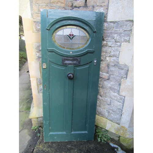 2077 - A 1930s painted front door with oval leaded light panel and irpn fittings, 84cm wide x 198cm high