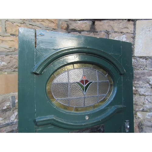 2077 - A 1930s painted front door with oval leaded light panel and irpn fittings, 84cm wide x 198cm high