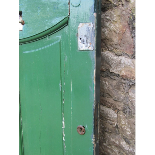 2077 - A 1930s painted front door with oval leaded light panel and irpn fittings, 84cm wide x 198cm high