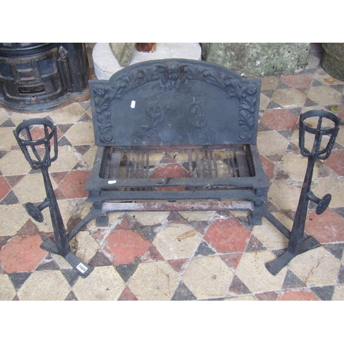 2088 - An Arts and crafts style cast iron fire basket and combined dogs the arched back plate with raised r... 