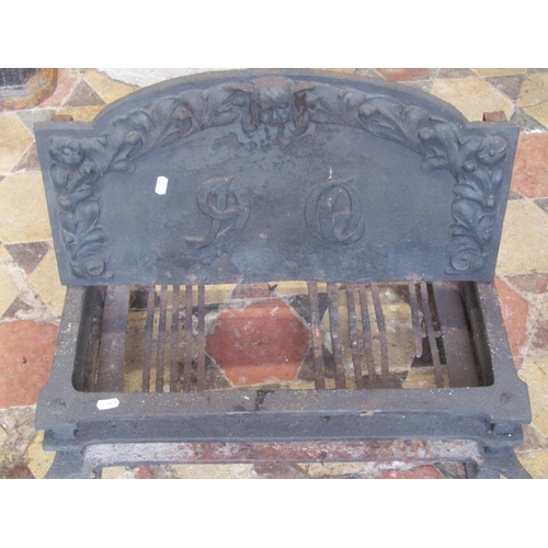 2088 - An Arts and crafts style cast iron fire basket and combined dogs the arched back plate with raised r... 