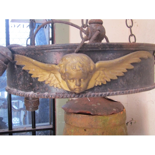 2120 - A run of four large iron work ceiling light fittings with gilt painted highlighted winged cherub det... 